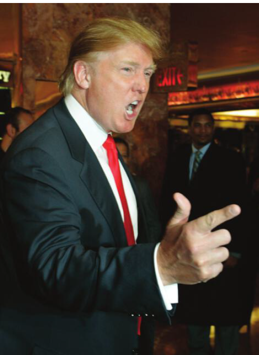Image in the article "Hands of Donald Trump" providing an example of Trump’s Pistol Hand gesture, The Apprentice (2006), Associated Press Images.